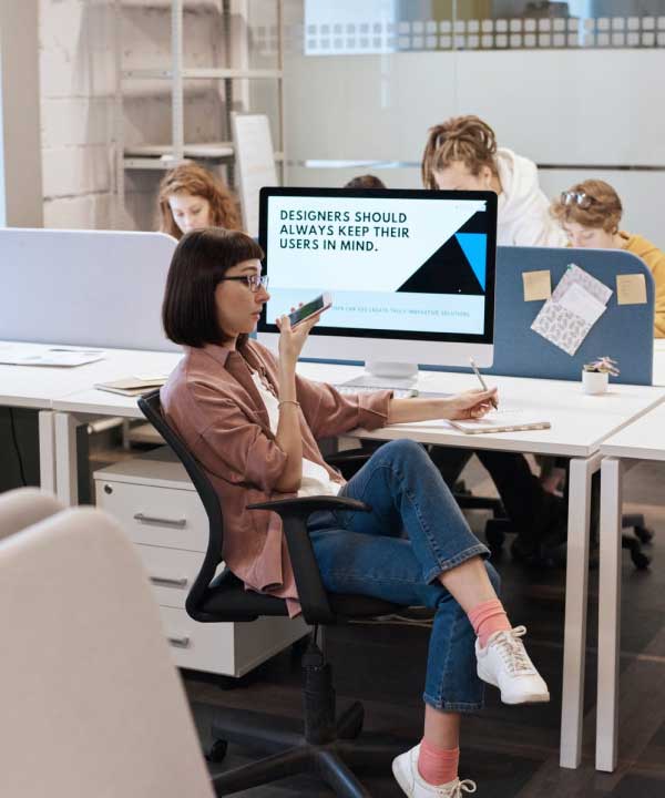 A woman sitting at her desk in front of a computer.